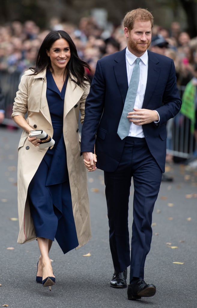 Martin Grant - PRINCE HARRY AND MEGHAN, THE DUCHESS OF SUSSEX IN MELBOURNE, AUSTRALIA. MEGHAN IS WEARING MARTIN GRANT BEIGE TRENCH COAT FROM RESORT SS19 COLLECTION. 